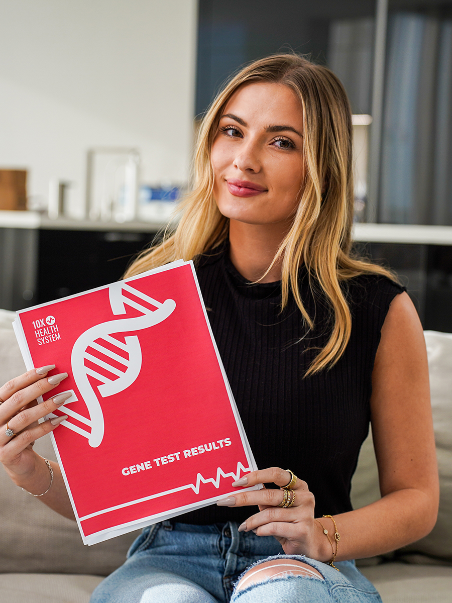 woman holding 10X Health gene test results folder