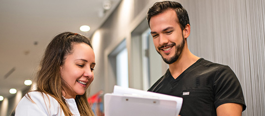 a 10X Health team member speaking to a visitor at a clinic