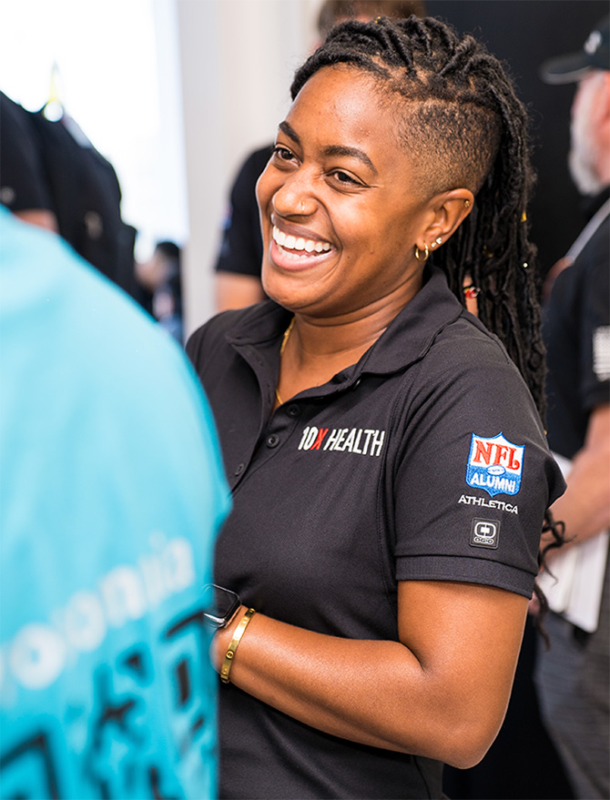 10X Health team member smiling at an event