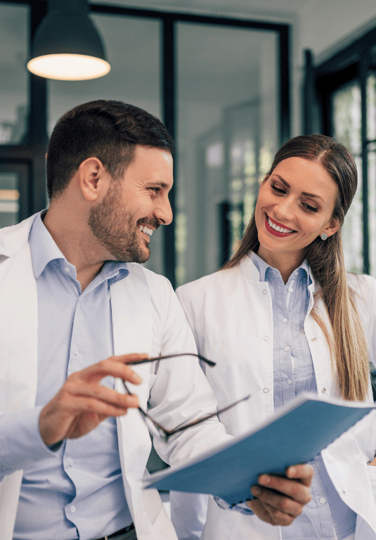 two healthcare providers reviewing notes
