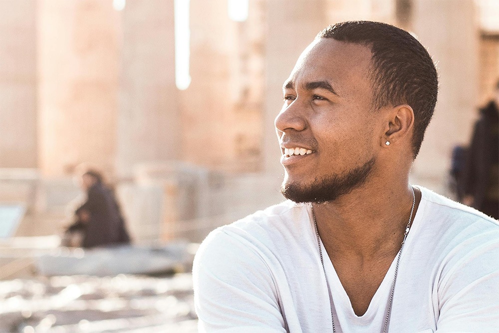 a man looking happily toward the horizon