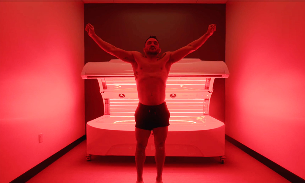 a man stretching after laying in a 10X Health red light therapy bed