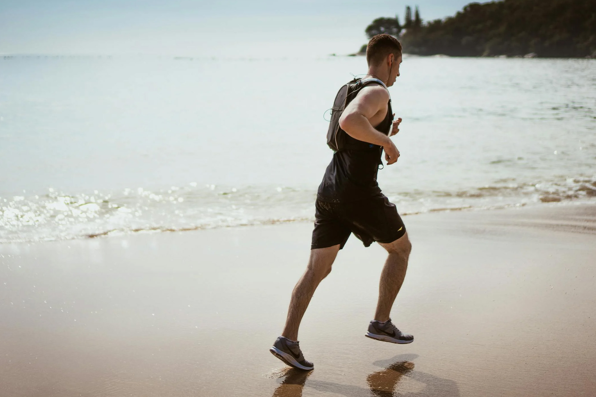 a man running on the beach